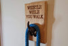 Oak Block with an cast iron tail holding a blue dog lead engraved with Whistle While You Walk 