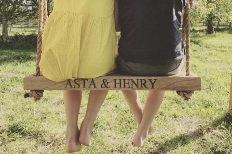 solid oak swing engraved with children's names 
